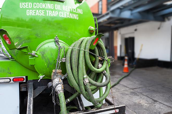 a vacuum truck pumping out a large underground grease trap in Belvedere, CA